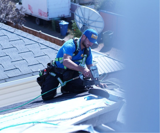 Roofer with nailgun