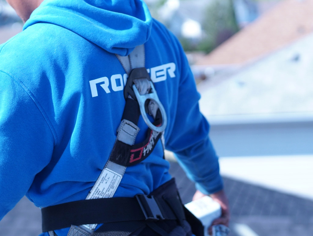 Roofer with safety harness