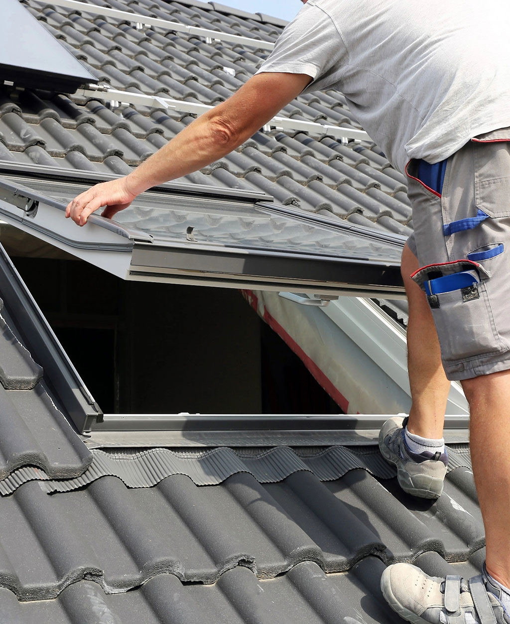 Roofer installing skylight